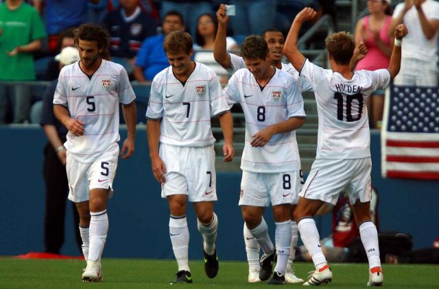 The USA national football team celebrate a goal against Grenada